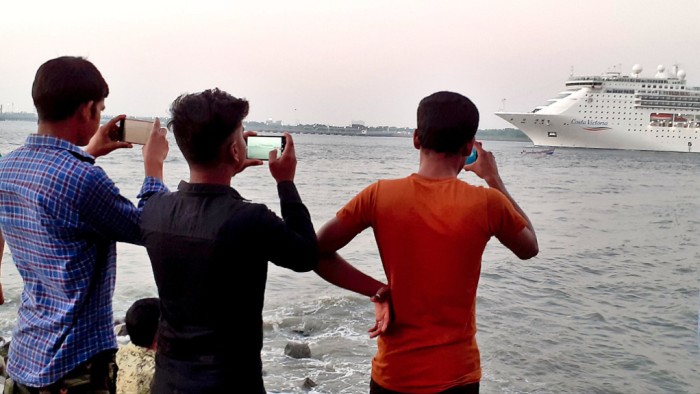 guys filming passing ship
