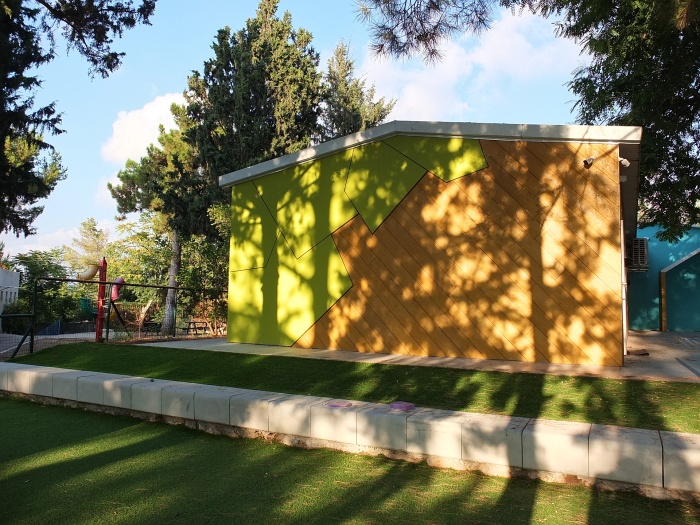 school building with shadows of trees